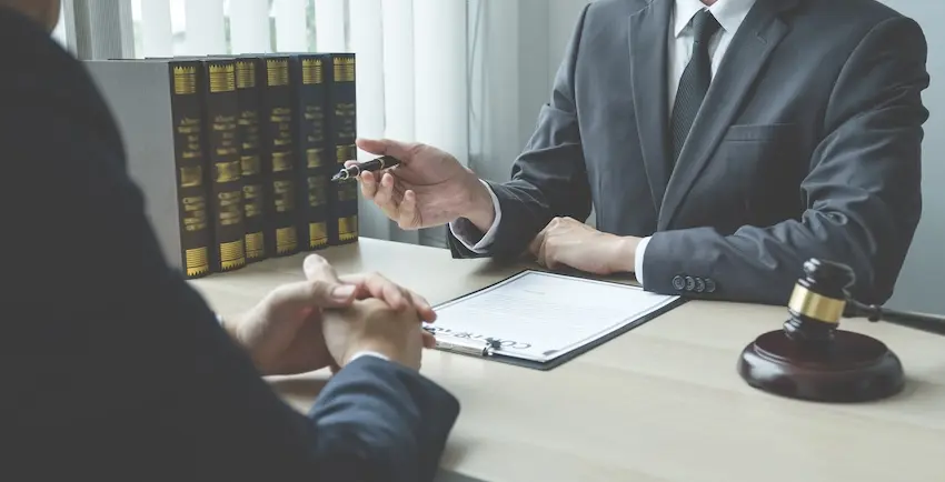 Charlotte car accident lawyer reviewing weather related crash claim with client