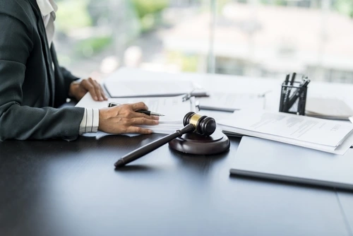 Charlotte pedestrian accident lawyer working at a desk with a judge’s gavel